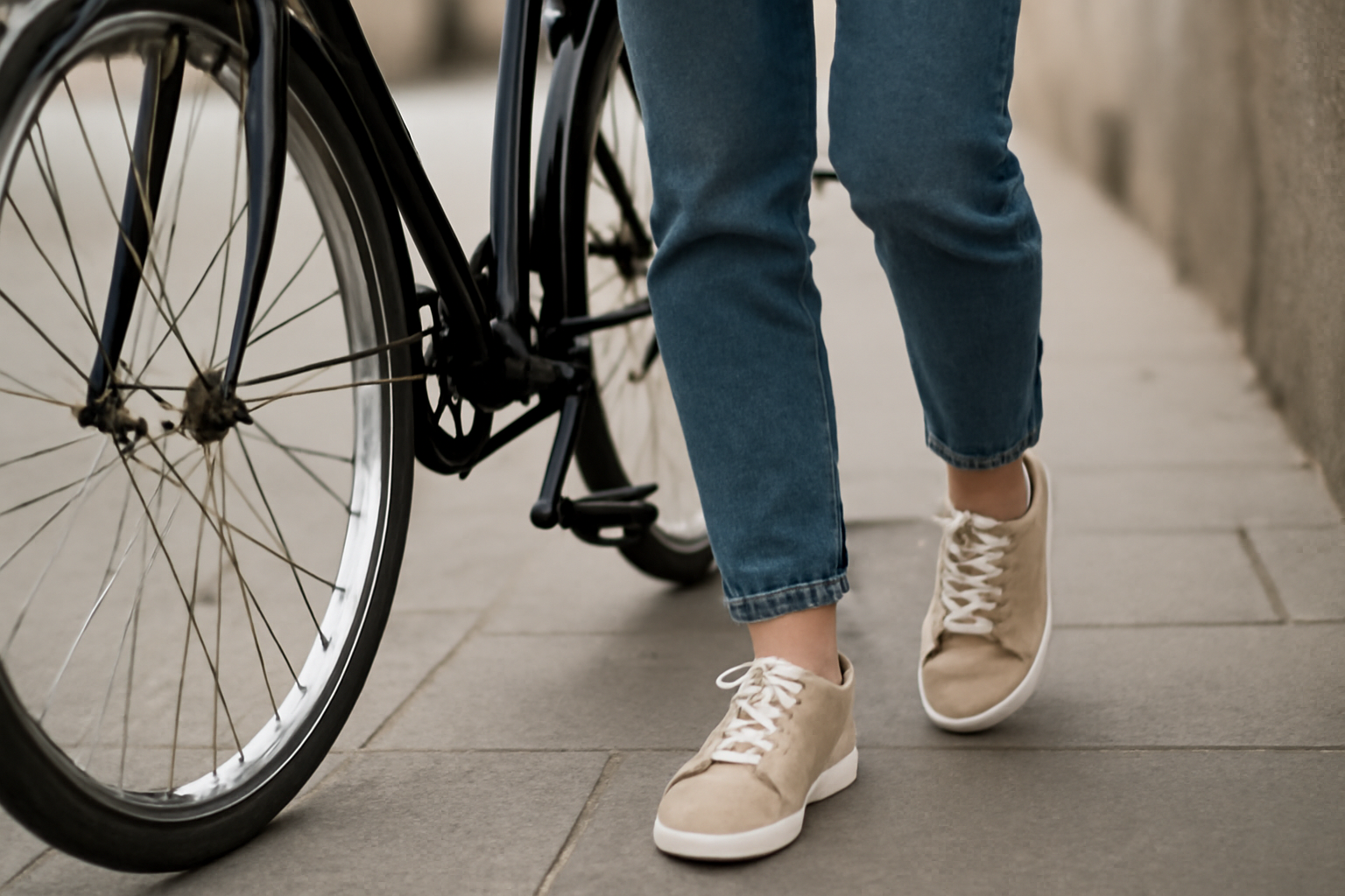 magasindemode-chaussures-velo-urbain personne en baskets marchant près d'un vélo